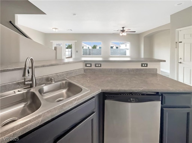 kitchen with a sink, a wealth of natural light, gray cabinets, and dishwasher