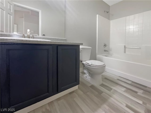 bathroom featuring vanity, toilet, and wood finished floors