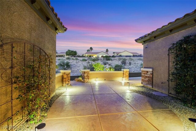 view of patio terrace at dusk