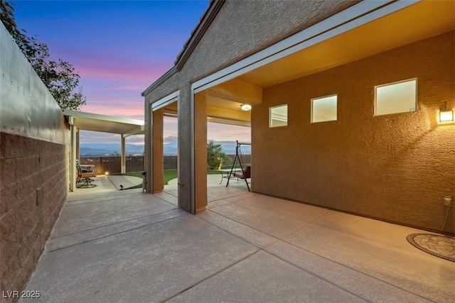 view of patio terrace at dusk