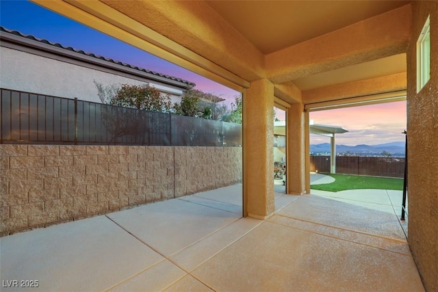 view of patio with a fenced backyard and a mountain view