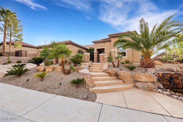 mediterranean / spanish-style home with stucco siding and a tile roof