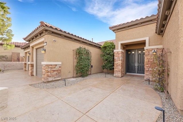 view of patio / terrace with a garage and driveway