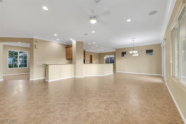 unfurnished living room featuring baseboards, ornamental molding, light tile patterned flooring, and ceiling fan with notable chandelier