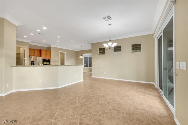 unfurnished living room with an inviting chandelier, baseboards, visible vents, and ornamental molding