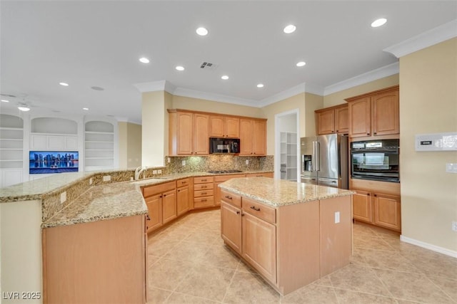 kitchen featuring visible vents, a kitchen island, light stone countertops, a peninsula, and black appliances