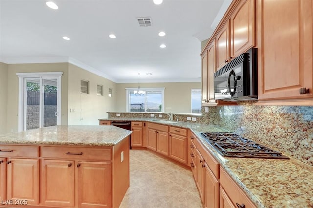 kitchen with a sink, black appliances, crown molding, and light brown cabinetry