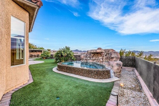 view of yard featuring a mountain view and a fenced backyard