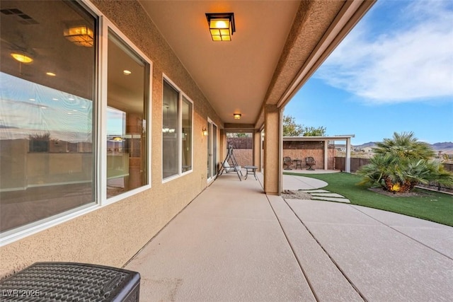 view of patio / terrace featuring fence