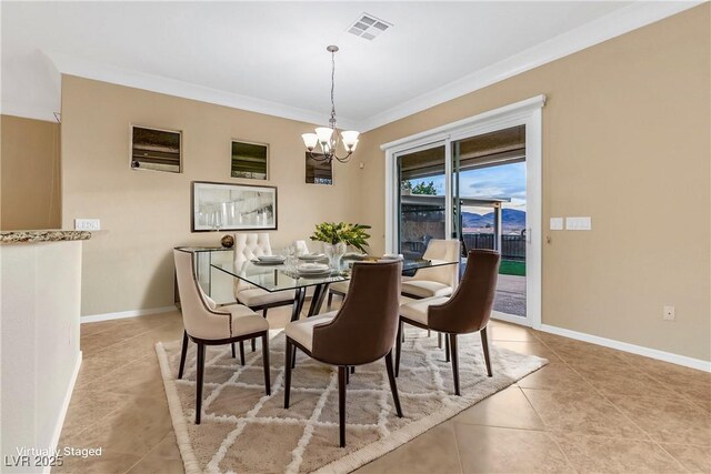 dining area with an inviting chandelier, crown molding, visible vents, and baseboards