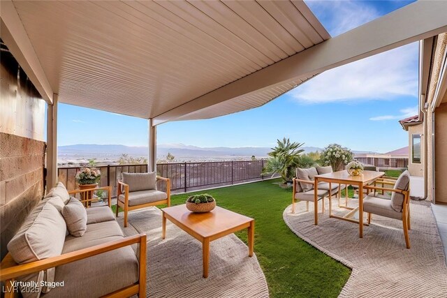 view of patio / terrace featuring a mountain view, a fenced backyard, and outdoor lounge area