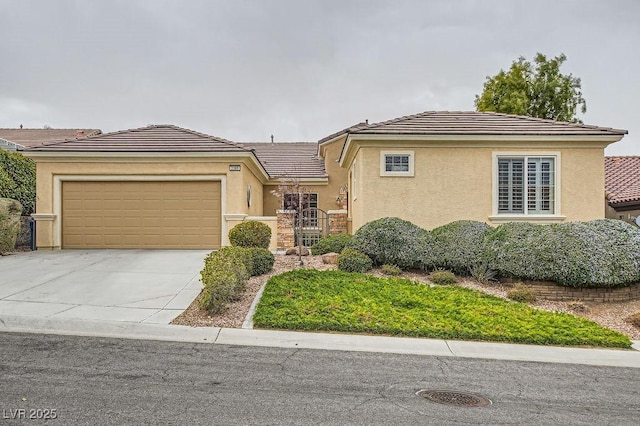 view of front of house featuring a garage, a tile roof, driveway, and stucco siding