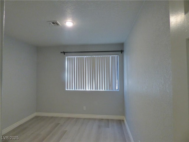 5044 S Rainbow Blvd Unit 106, Las Vegas, NV 89118 - empty room with visible vents, baseboards, and wood finished floors