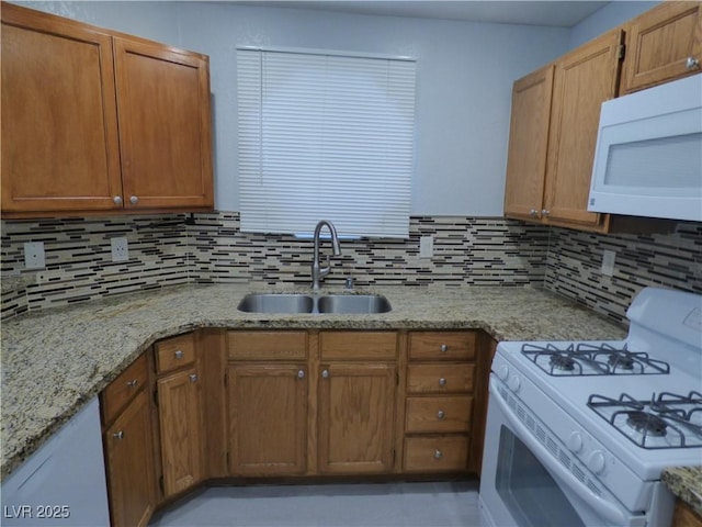5044 S Rainbow Blvd Unit 106, Las Vegas, NV 89118 - kitchen with a sink, tasteful backsplash, white appliances, brown cabinets, and light stone counters