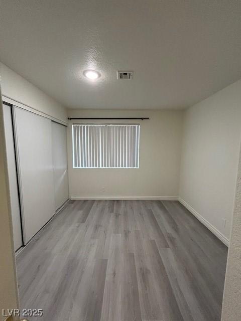 5044 S Rainbow Blvd Unit 106, Las Vegas, NV 89118 - empty room with wood finished floors, visible vents, and baseboards