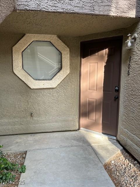 5044 S Rainbow Blvd Unit 106, Las Vegas, NV 89118 - doorway to property with stucco siding