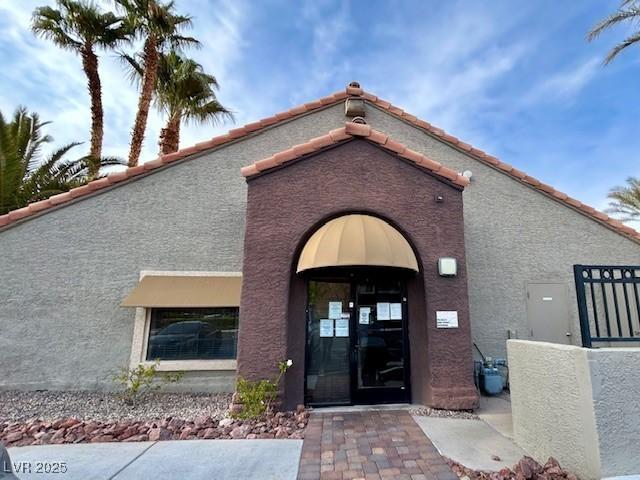 5044 S Rainbow Blvd Unit 106, Las Vegas, NV 89118 - entrance to property with a tiled roof and stucco siding
