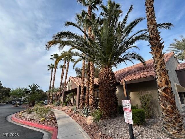 5044 S Rainbow Blvd Unit 106, Las Vegas, NV 89118 - view of side of home featuring a tile roof and stucco siding