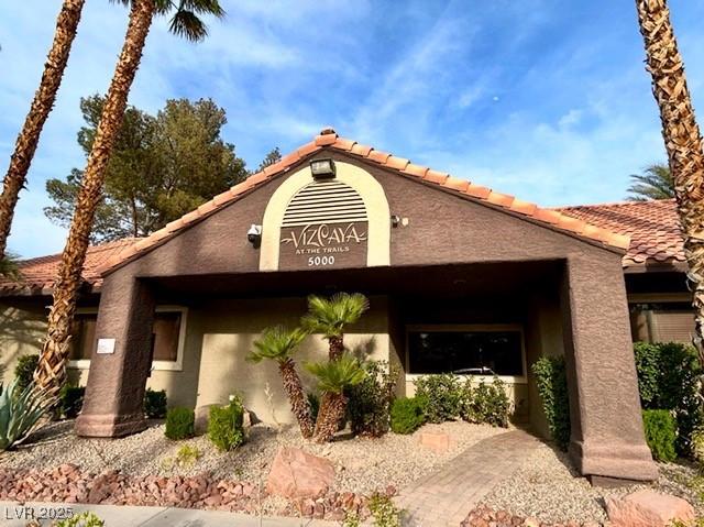 5044 S Rainbow Blvd Unit 106, Las Vegas, NV 89118 - view of front of house featuring a tile roof and stucco siding