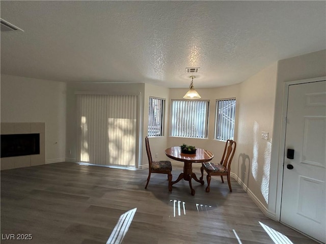 5044 S Rainbow Blvd Unit 106, Las Vegas, NV 89118 - dining space with a textured ceiling, wood finished floors, visible vents, and baseboards