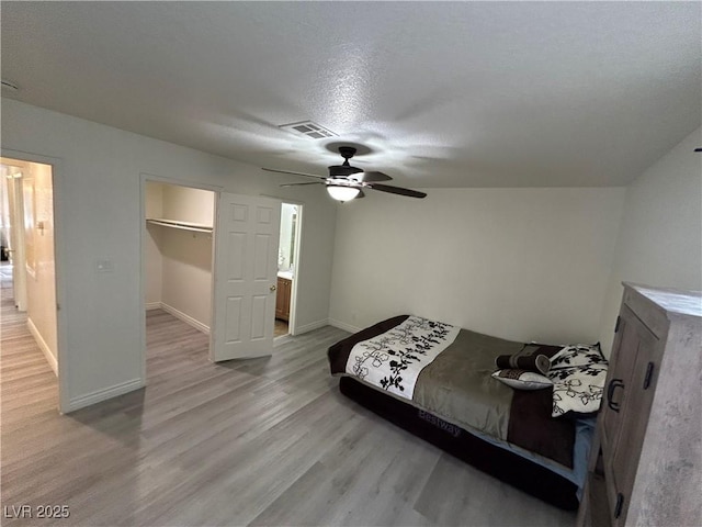 5044 S Rainbow Blvd Unit 106, Las Vegas, NV 89118 - bedroom with baseboards, visible vents, a spacious closet, light wood-style floors, and ceiling fan