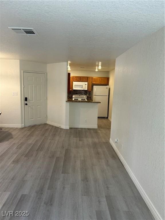 5044 S Rainbow Blvd Unit 106, Las Vegas, NV 89118 - unfurnished living room with baseboards, a textured ceiling, and visible vents