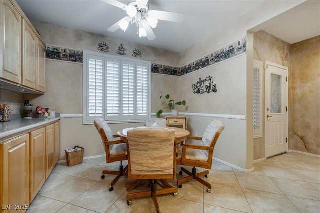 dining area featuring light tile patterned floors, baseboards, and a ceiling fan