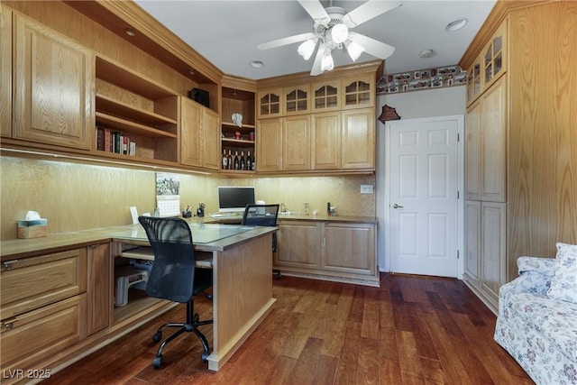 home office featuring dark wood-style floors, built in desk, and a ceiling fan