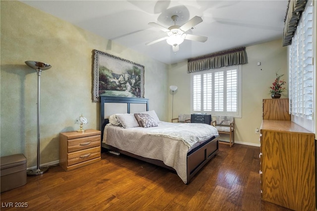 bedroom featuring dark wood-style floors, a ceiling fan, and baseboards