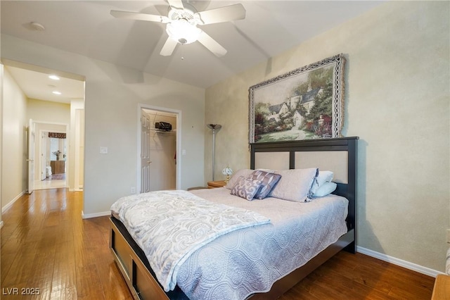 bedroom featuring ceiling fan, baseboards, and wood finished floors