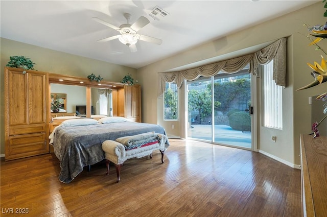 bedroom featuring dark wood-type flooring, access to outside, visible vents, and baseboards