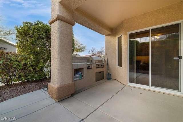 view of patio / terrace featuring exterior kitchen and area for grilling