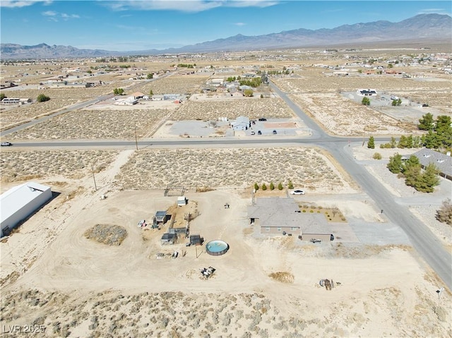 birds eye view of property with a desert view and a mountain view