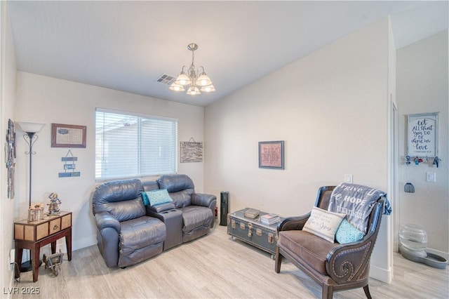 living room featuring a chandelier, wood finished floors, visible vents, and baseboards