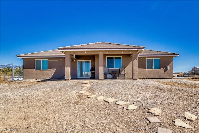 rear view of property with stucco siding