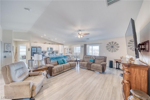 living room with lofted ceiling, ceiling fan, recessed lighting, visible vents, and light wood-style floors