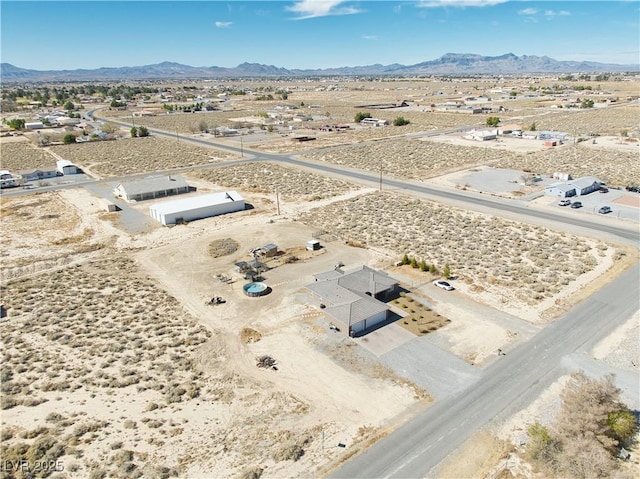 bird's eye view with a desert view and a mountain view