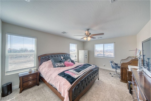 bedroom with visible vents, a ceiling fan, light carpet, a textured ceiling, and baseboards