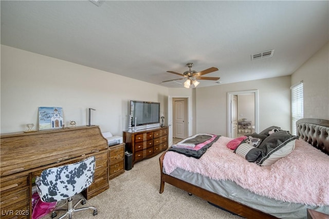 bedroom featuring a ceiling fan, visible vents, and light colored carpet