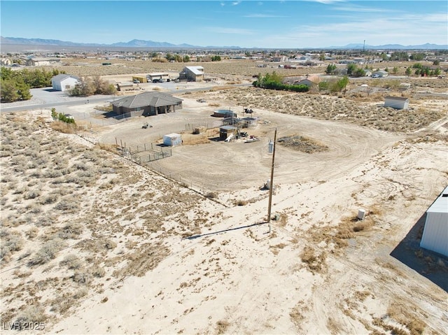 drone / aerial view with view of desert and a mountain view