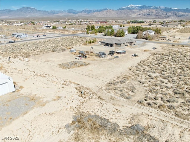 birds eye view of property with a mountain view and view of desert