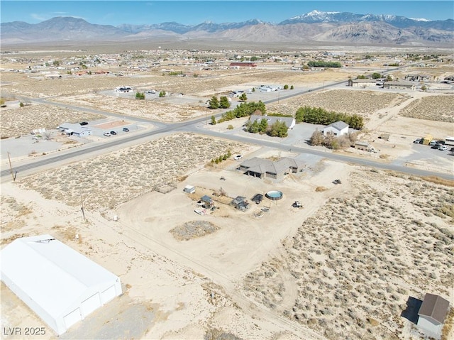 birds eye view of property featuring a desert view and a mountain view