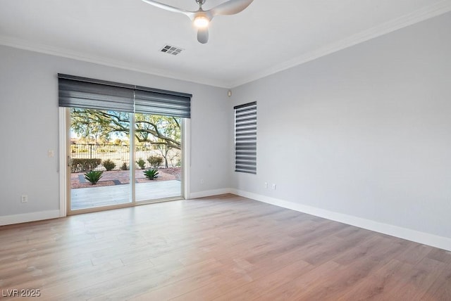 empty room with visible vents, baseboards, light wood-style flooring, ceiling fan, and ornamental molding