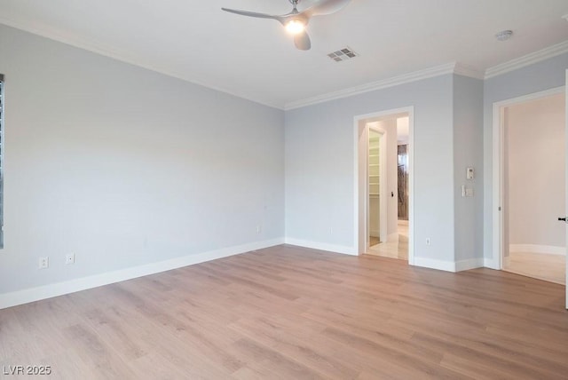 unfurnished room with ceiling fan, visible vents, baseboards, ornamental molding, and light wood finished floors