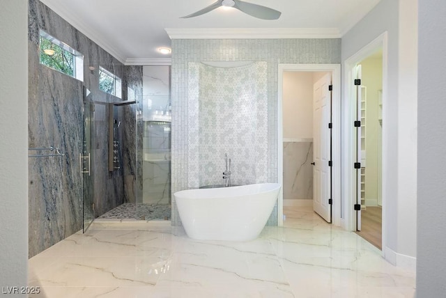 bathroom with a marble finish shower, ceiling fan, marble finish floor, crown molding, and a freestanding tub