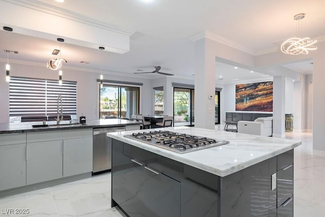 kitchen featuring modern cabinets, marble finish floor, stainless steel appliances, crown molding, and a sink