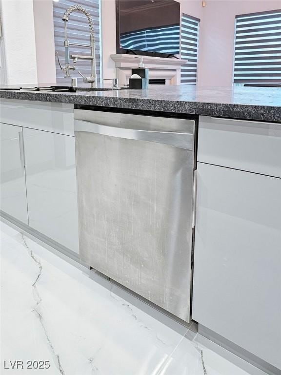 details featuring white cabinets, dishwasher, and oven