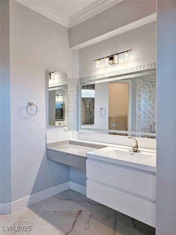 full bath with baseboards, marble finish floor, vanity, and crown molding