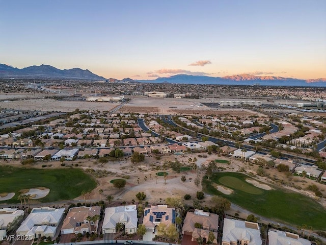 drone / aerial view featuring a mountain view, golf course view, and a residential view