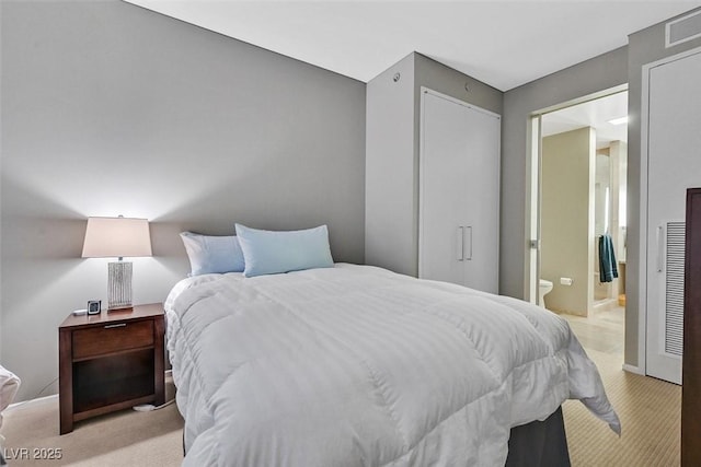 bedroom with light carpet, a closet, connected bathroom, and visible vents